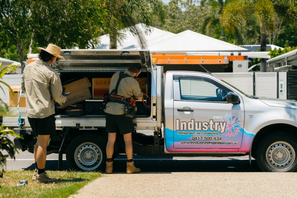 Industry Refrigeration crew and service vehicles set up at a job site