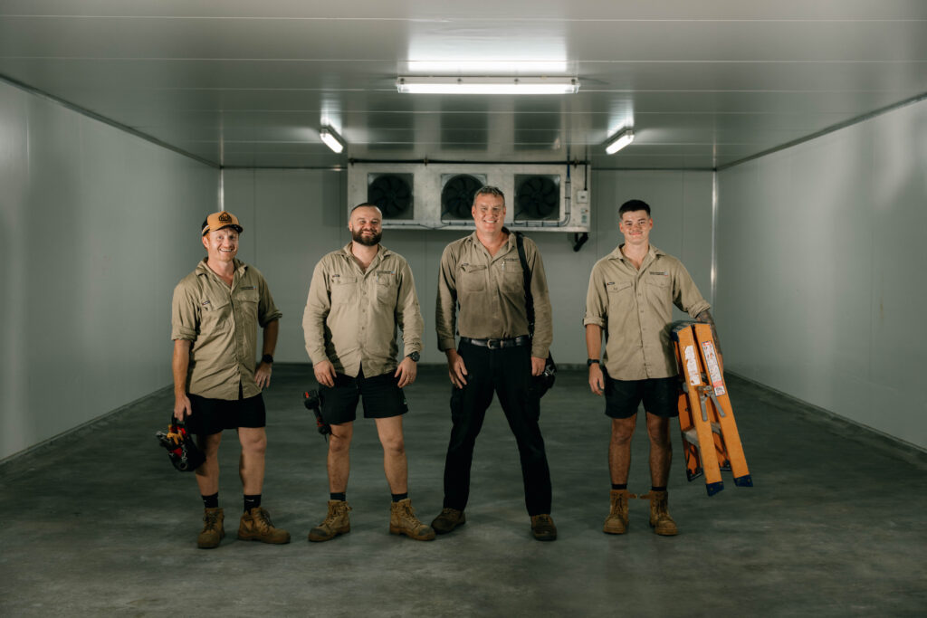 Four Industry Refrigeration technicians inside a newly built commercial coolroom